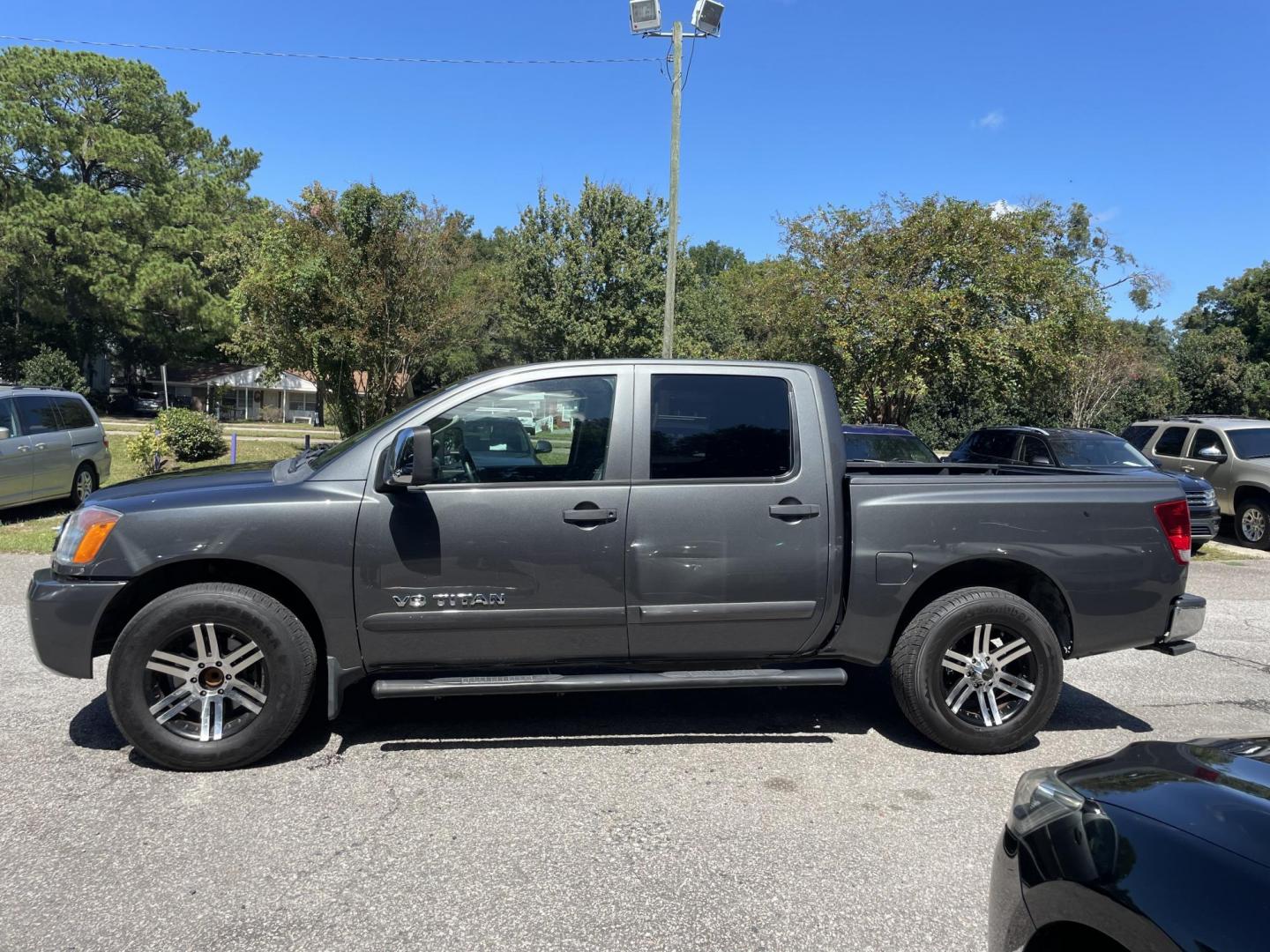 2012 GRAY NISSAN TITAN SV (1N6BA0ED8CN) with an 5.6L engine, Automatic transmission, located at 5103 Dorchester Rd., Charleston, SC, 29418-5607, (843) 767-1122, 36.245171, -115.228050 - Local Trade-in with Clean Interior, CD/AUX, Power Everything (windows, locks, seat, mirrors), Keyless Entry, Running Boards, Tow Package, Bed Liner, Alloy Wheels. Clean CarFax (no accidents reported!) 145k miles Located at New Life Auto Sales! 2023 WINNER for Post & Courier's Charleston's Choice Pr - Photo#3