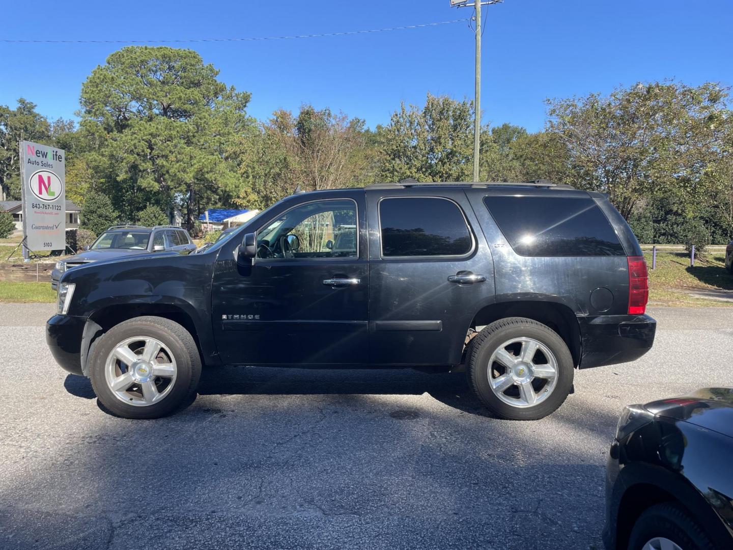 2007 BLACK CHEVROLET TAHOE LTZ (1GNFK13057R) with an 5.3L engine, Automatic transmission, located at 5103 Dorchester Rd., Charleston, SC, 29418-5607, (843) 767-1122, 36.245171, -115.228050 - Leather, Sunroof, Navigation, Backup Camera, CD/Aux/Sat, OnStar, Dual Climate Control, Power Everything (windows, locks, seats, mirrors), Heated/Memory Seating, Power Liftgate, Keyless Entry, Middle Row Captain's Seats, Convenient Third Row, Alloy Wheels. 226k miles Located at New Life Auto Sales! - Photo#4